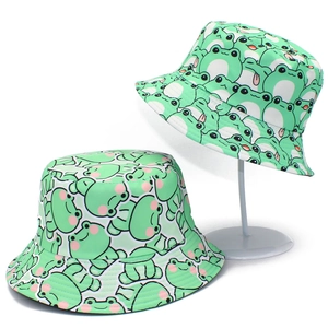 Cute green frog bucket hat with cartoon pattern shown on a stand and flat view