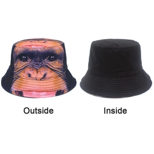 Detailed view of reversible bucket hat with realistic orangutan print and solid black lining