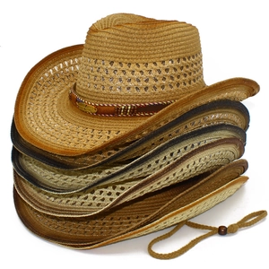 Detail of multi-colored straw cowboy hats featuring leather bands and metal feather charms