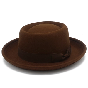 Close-up of wool pork pie hat with ribbed ribbon and bow detail in dark brown