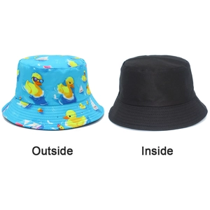 Dual-sided bucket hat featuring light blue cartoon duck print and solid black reverse