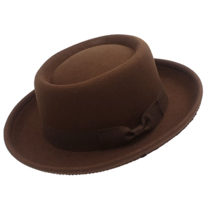 Detail of dark brown pork pie hat showing felt texture and grosgrain bow ribbon