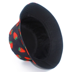 Close-up of strawberry print patterns on double-sided black cotton bucket hat fabric