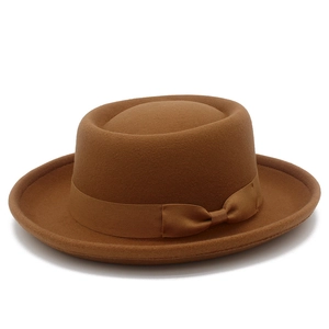 Close-up of the fine wool felt texture and elegant ribbon bow on the brown fedora hat