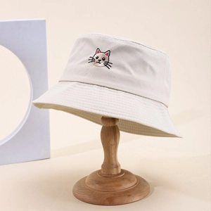 Beige cotton bucket hat featuring a cute cartoon cat embroidery for outdoor sun protection
