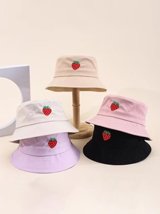 Detailed close-up of colorful strawberry embroidery on diverse cotton bucket hats