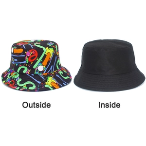 Detail view of reversible bucket hat showing colorful graffiti print and solid black lining