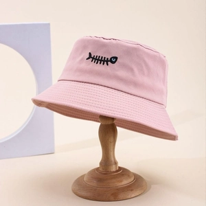Cappello a secchiello rosa in cotone con ricamo a lisca di pesce su supporto legno