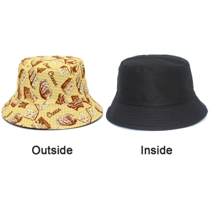 Detail of reversible bucket hat with yellow cheese pattern and solid black inner side