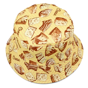 Detailed pattern of cheese and baguette illustrations on a yellow twill bucket hat