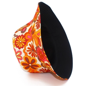Detail of floral bucket hat with colorful flower patterns and reversible black lining