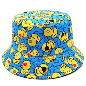 Detailed pattern of yellow duck prints on a blue bucket hat with geometric accents