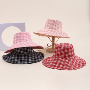 Detailed view of plaid wide-brim sun hats in various colors with adjustable windproof straps