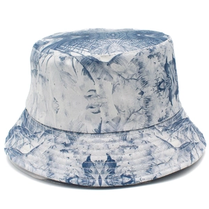 Classic reversible bucket hat featuring blue and white tropical pattern on white background