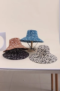 Dettaglio di cappelli da sole floreali con corde regolabili in quattro colori e tesa larga