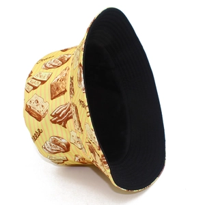 Detail of yellow bucket hat with cheese prints, orange stripes and black inner lining