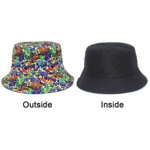 Detailed view showing the dual-sided design of bucket hat with graffiti and solid black