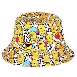 Detailed view of stylized yellow duck pattern on white cotton reversible bucket hat