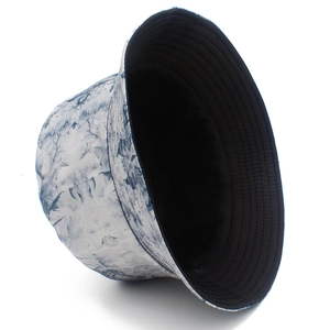 Detail showing high-quality stitching and ink-print pattern on a reversible bucket hat