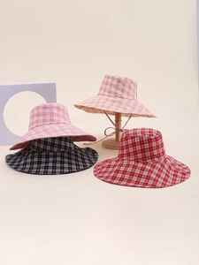 Detail view of stylish checkered sun hats with wide brims and adjustable chin straps
