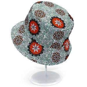 Close-up of the geometric patterns and orange floral print on the fabric bucket hat