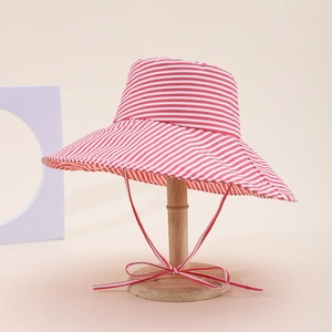 Detail of red and white striped wide brim sun hat with adjustable chin strap