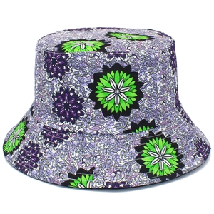 Detailed view of vibrant green and purple floral patterns on a stylish fabric bucket hat