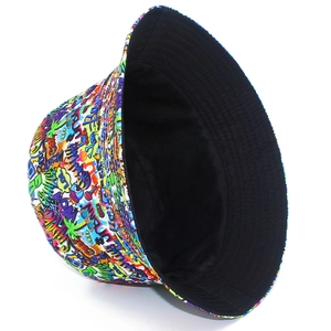 Detail of reversible bucket hat showing colorful street graffiti print and black lining