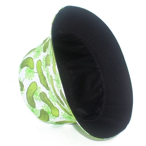 Detail of reversible bucket hat with green pickle print on white and solid black interior