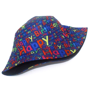 Detailed view of dark blue bucket hat with colorful Happy Birthday print and black lining