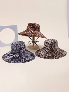 Three leopard print sun hats in tan, grey, and brown with wide brims and adjustable straps