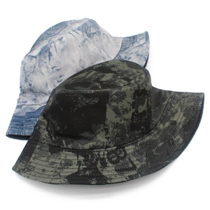 Detail view of double-sided bucket hats featuring abstract art prints and reinforced stitching