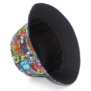 Detail of colorful graffiti bucket hat showing artistic print and black fabric lining