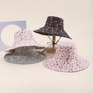 Detail of floral bucket hats with windproof strings in black, beige, pink and green