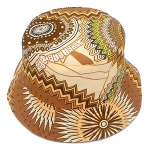 Detailed view of tribal geometric pattern on a canvas bucket hat with earth-tone colors