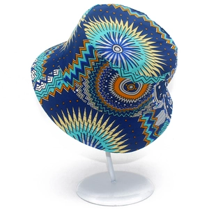 Close-up of ethnic geometric sun patterns on navy blue fabric bucket sun hat