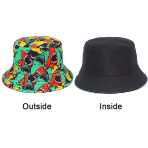 Detail showing reversible shark print bucket hat with bright multicolor patterns and black inside