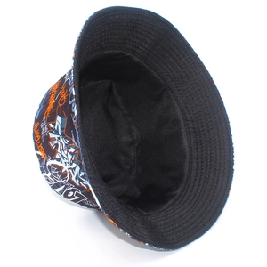 Detail of street style bucket hat featuring vibrant graffiti prints and reinforced stitching