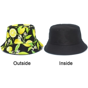 Detailed view of reversible bucket hat with lemon fruit print and solid black inner side