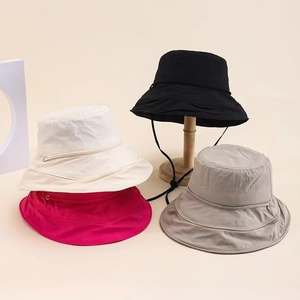 Macro detail of quick-dry sun hats with adjustable drawstrings in assorted colors