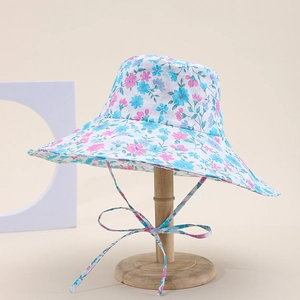 Close-up of a floral print cotton bucket hat with a wide brim and matching chin strap