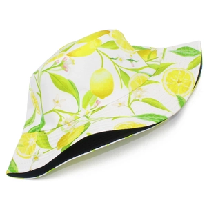 Detail of white bucket hat featuring fresh yellow lemon and green leaf pattern print