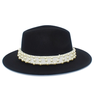 Detailed view of the black wool fedora hat with white ribbon and faux pearl embellishments