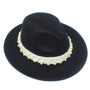 Close-up of black wool Fedora hat featuring a white band with elegant faux pearl embellishments