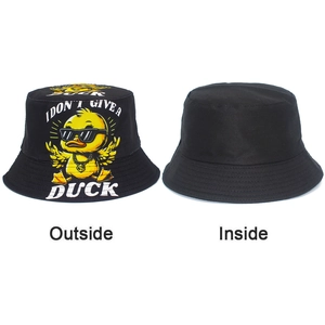 Detail showing the reversible design of the black bucket hat with cartoon duck print