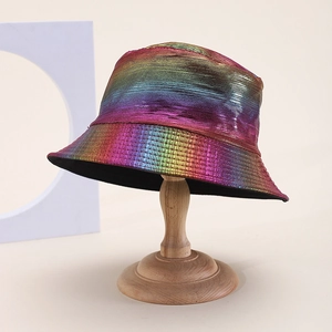 Rainbow gradient metallic PU bucket hat with textured finish on wooden display stand