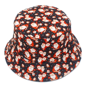 Close-up of Santa Claus and snowflake prints on the black cotton fabric bucket hat