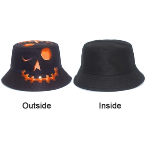Detail showing the reversible bucket hat with Halloween pumpkin face and plain black inside