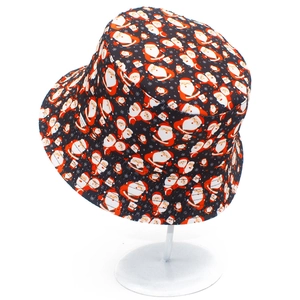 Close-up of black bucket hat with festive red and white Santa Claus pattern print