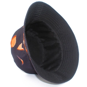 Detail view of the interior lining and orange pumpkin print on this black cotton bucket hat